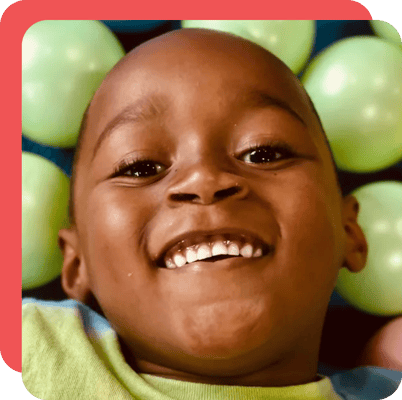 Child laying in a ball pit