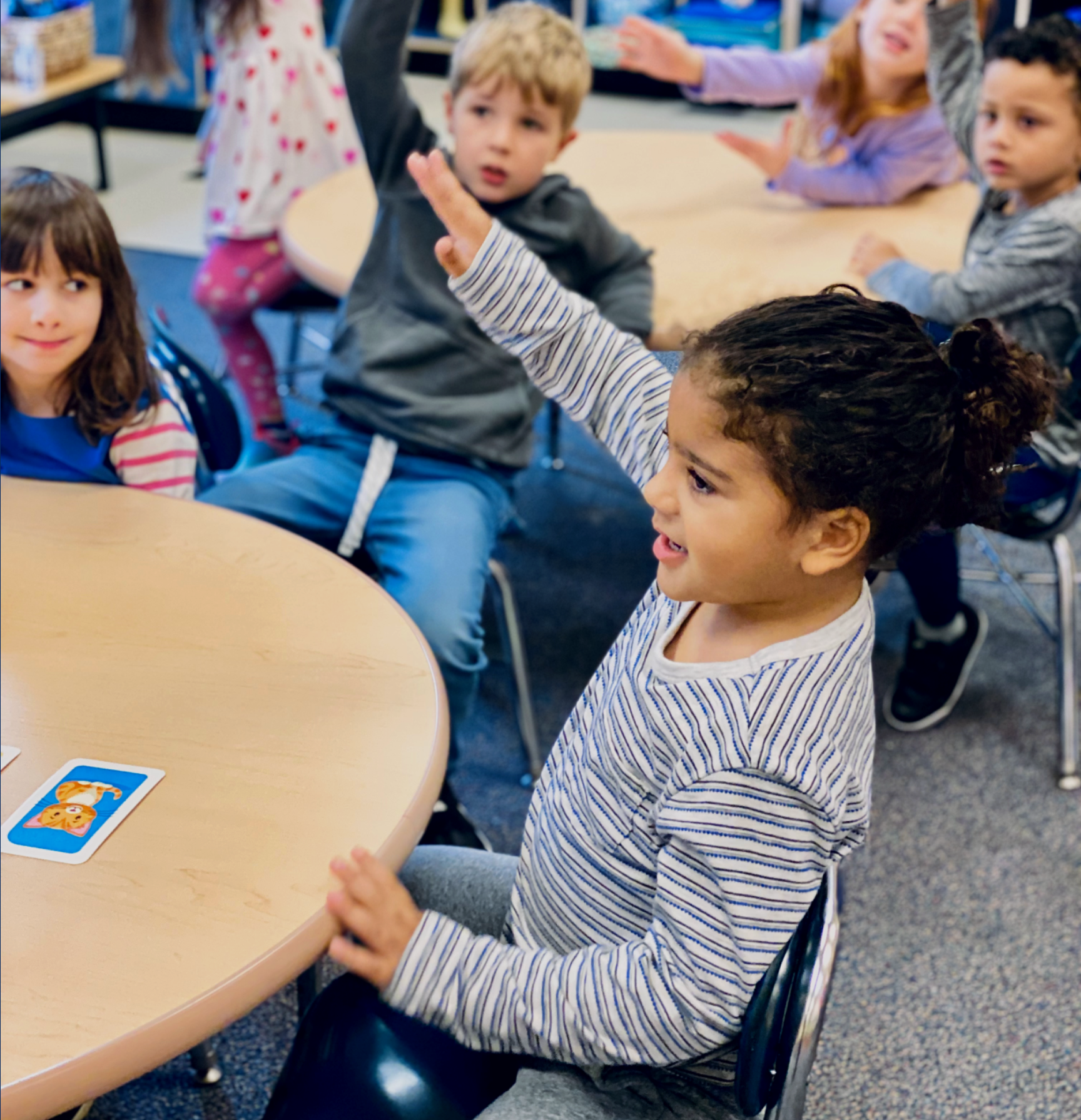 Child raising their hand in a classroom-1