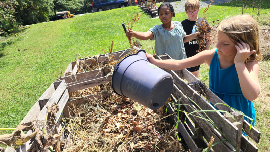 Young students cleaning up a community garden