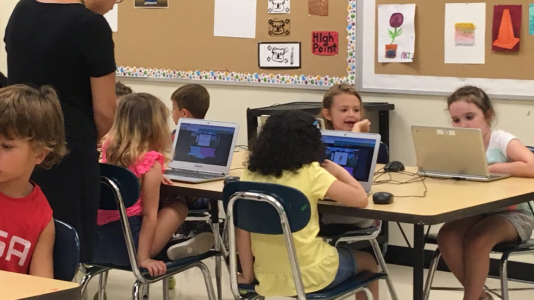 Young students learning to use a computer