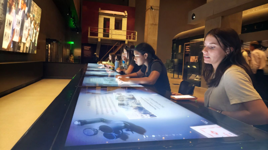Middle schoolers learning at a museum during a field trip