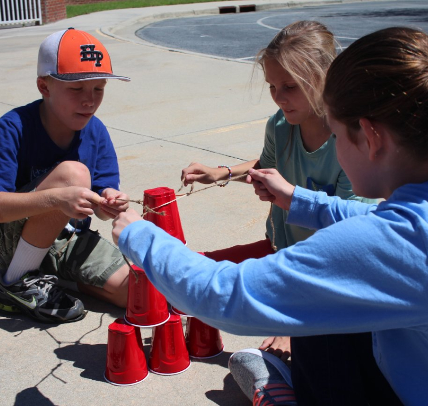 Children using teamwork to accomplish a task